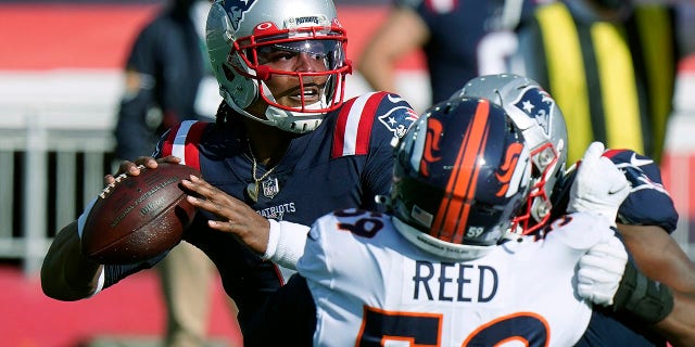 New England Patriots quarterback Cam Newton, right, passes under pressure from Denver Broncos linebacker Malik Reed (59) in the second half of an NFL football game, Sunday, Oct. 18, 2020, in Foxborough, Mass. (AP Photo/Steven Senne)