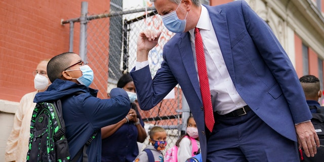 New York Mayor Bill de Blasio greets students as they arrive for in-person classes Tuesday in the Manhattan borough of New York City. (AP)