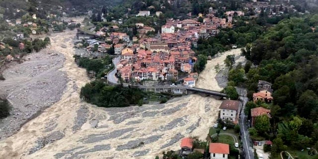 This aerial view provided Sunday Oct.4, 2020 by the Alpes Maritimes region fire brigade show a house keeping a fragile balance on a hill while a rive floods Saturday Oct.3. 2020 near La Vesubie, southern France.