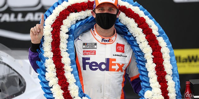 TALLADEGA, ALABAMA - OCTOBER 04: Denny Hamlin, driver of the #11 FedEx Express Toyota, celebrates in Victory Lane after winning the NASCAR Cup Series YellaWood 500 at Talladega Superspeedway on October 04, 2020 in Talladega, Alabama. (Photo by Chris Graythen/Getty Images)