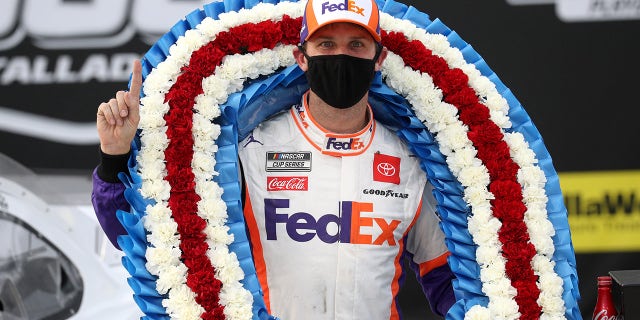 TALLADEGA, ALABAMA - OCTOBER 04: Denny Hamlin, driver of the #11 FedEx Express Toyota, celebrates in Victory Lane after winning the NASCAR Cup Series YellaWood 500 at Talladega Superspeedway on October 04, 2020 in Talladega, Alabama. (Photo by Chris Graythen/Getty Images)