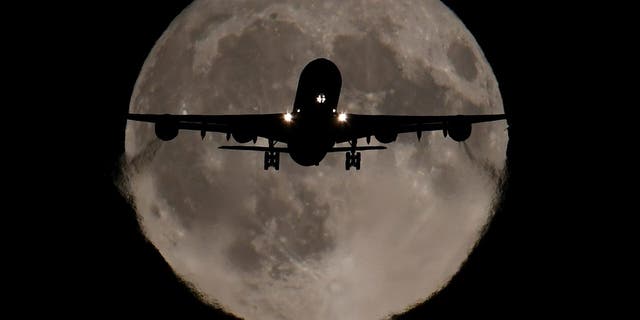 A passenger plane, with a full Harvest moon seen behind, makes its final landing approach towards Heathrow Airport in London. REUTERS/Toby Melville (REUTERS/Toby Melville)