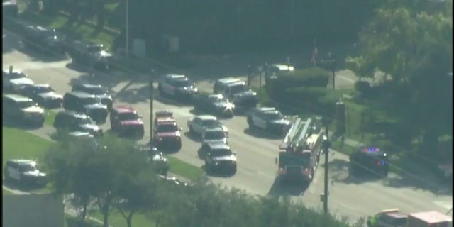 Police vehicles at the scene where two officers were shot in southwest Houston on Tuesday.