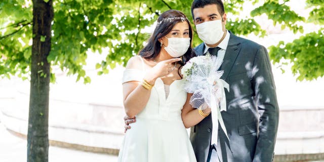 Couples around the globe are adjusting their wedding plans due to the coronavirus pandemic, according to The Knot Worldwide. (iStock)