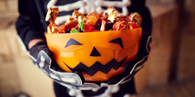 Prep bowls of individually wrapped candies ahead of time and leave them at the edge of the driveway or lawn, one expert advised. (iStock).