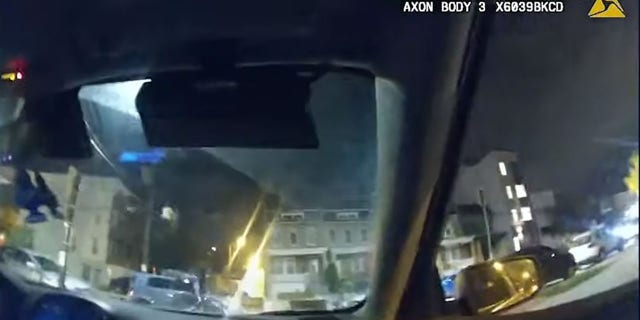 This image from an officer-worn body camera shows the moment Hylton's moped strikes the side of a vehicle.