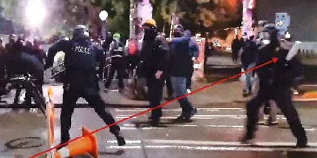 Livestream footage shows Greenburg with a bat running toward Officer Jimenez as he wrestles another suspect for his bike. (King County Prosecutor's Office).