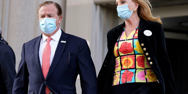 Mark and Patricia McCloskey leave following a court hearing Wednesday in St. Louis. The McCloskeys have pleaded not guilty to two felony charges, unlawful use of a weapon and tampering with evidence, after they were seen waving guns at protesters marching on their private street this past summer. (AP Photo/Jeff Roberson)