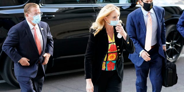 Mark and Patricia McCloskey arrive for a court hearing along with their attorney, Joel Schwartz, right, on Wednesday in St. Louis. (AP Photo/Jeff Roberson)