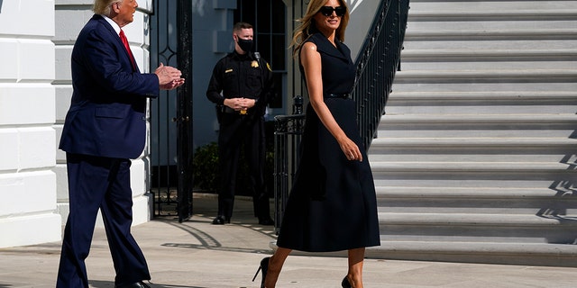 President Donald Trump and first lady Melania Trump walk to board Marine One on the South Lawn of the White House, Thursday, Oct. 22, 2020, in Washington. Trump is headed to Nashville, Tenn., for a debate. (AP Photo/Alex Brandon)