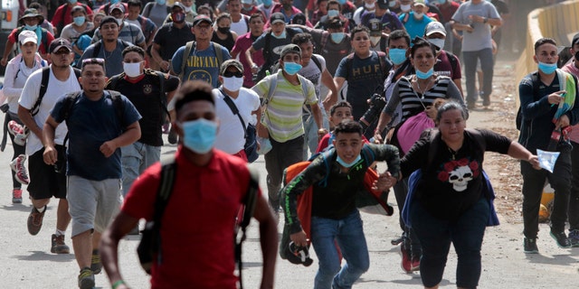 Migrants cross the border from Corinto, Honduras, into Corinto, Guatemala, on Thursday. (AP)