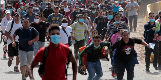 Migrants cross the border from Corinto, Honduras, into Corinto, Guatemala, on Thursday. (AP)