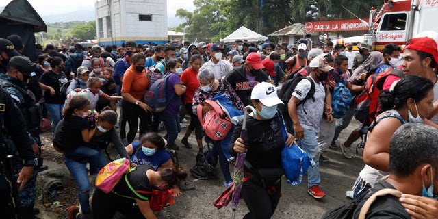 At the Honduras-Guatemala border, the migrants pushed past outnumbered Guatemalan police and soldiers who made little attempt to stop them. (AP)