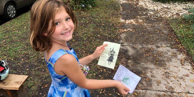 Cate Carroll shows off letters she's received from fairies in Norfolk, Va, on Monday Oct. 12, 2020.