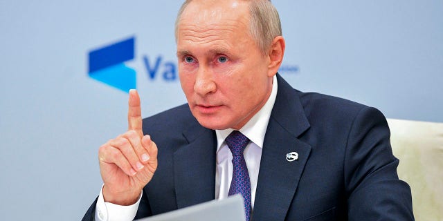 Russian President Vladimir Putin gestures while speaking at the annual meeting of the Valdai Discussion Club via video conference at the Novo-Ogaryovo residence outside Moscow, Russia, Thursday, Oct. 22, 2020. (Alexei Druzhinin, Sputnik, Kremlin Pool Photo via AP)