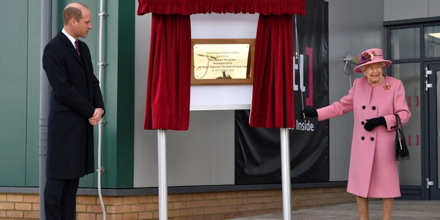 Britain's Prince William looks on as Queen Elizabeth II unveils a plaque to officially open the new Energetics Analysis Centre at the Defence Science and Technology Laboratory (DSTL) at Porton Down, England.