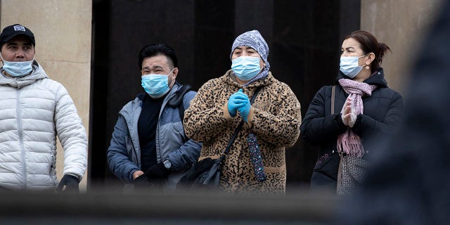 People wearing face masks to help curb the spread of the coronavirus leave a subway in Moscow, Russia, on Monday. Despite the sharp spike in daily new infections, Russian authorities have repeatedly dismissed the idea of imposing a second lockdown or shutting down businesses after most virus-related restrictions were lifted during the summer. (AP Photo/Alexander Zemlianichenko)