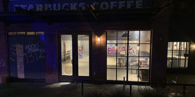 Police said protesters shattered the windows of a coffee shop and tossed an explosive inside on Saturday night.