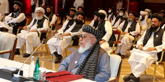 In this Sept. 12, 2020, file photo, Taliban negotiator Abbas Stanikzai, center front, and his delegation attend the opening session of peace talks between the Afghan government and the Taliban, in Doha, Qatar. Afghanistan’s Taliban on Thursday, Oct. 8, 2020, (AP Photo/Hussein Sayed, File)