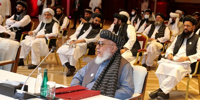 In this Sept. 12, 2020, file photo, Taliban negotiator Abbas Stanikzai, center front, and his delegation attend the opening session of peace talks between the Afghan government and the Taliban, in Doha, Qatar. Afghanistan’s Taliban on Thursday, Oct. 8, 2020, (AP Photo/Hussein Sayed, File)