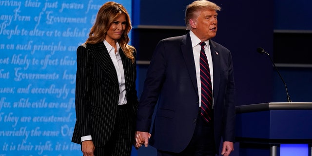 President Donald Trump and first lady Melania Trump onstage at the end of the first presidential debate Tuesday, Sept. 29, 2020, at Case Western University and Cleveland Clinic, in Cleveland. (Associated Press)