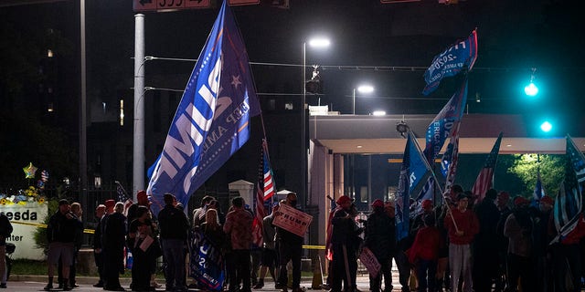 Supporters of President Donald Trump demonstrate at the entrance to Walter Reed National Military Medical Center in Bethesda, Md., Saturday, Oct. 3, 2020. Trump was admitted to the hospital after contracting the coronavirus. (AP Photo/Cliff Owen)
