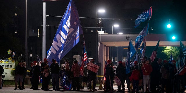 Supporters of President Donald Trump demonstrate at the entrance to Walter Reed National Military Medical Center in Bethesda, Md., Saturday, Oct. 3, 2020. Trump was admitted to the hospital after contracting the coronavirus. (AP Photo/Cliff Owen)