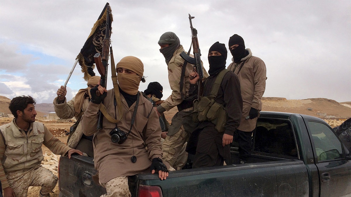 al Qaeda fighters with flags and guns