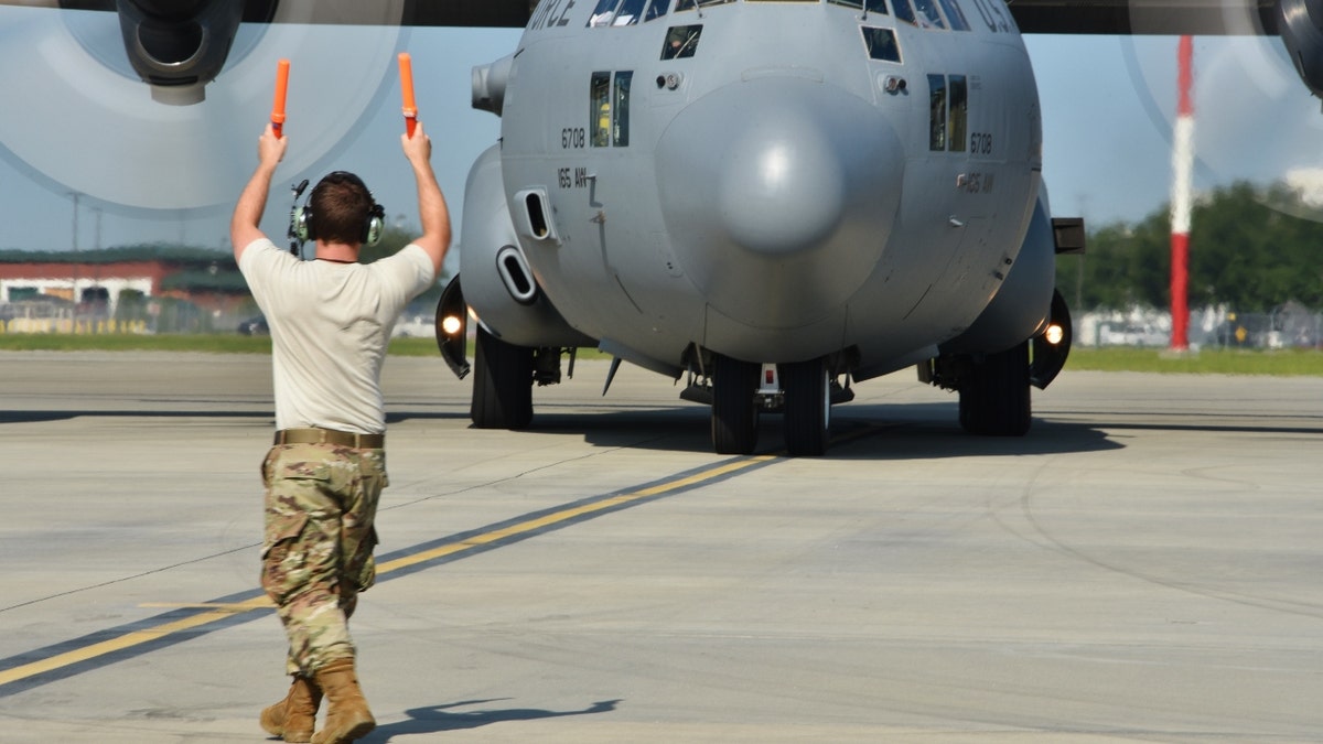 U.S. Air Force Tech. Sgt. Deklan Woolsey, 165th Airlift Wing crew chief, marshals a C-130H3 at Savannah Air National Guard Base, Savannah, Ga. (U.S. Air Force photo by Senior Airman Renee Crugnale)