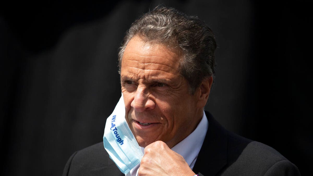 In this June 15 photo, New York Gov. Cuomo removes a mask as he holds a news conference in Tarrytown, N.Y.  (AP Photo/Mark Lennihan, File)