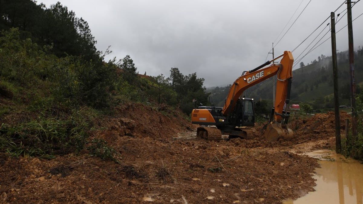 A backhoe clears a road blocked by debris brought on by a landslide in the aftermath of Hurricane Eta, in Purulha, northern Guatemala Nov. 6. As the remnants of Eta moved back over Caribbean waters, governments in Central America worked to tally the displaced and dead, and recover bodies from landslides and flooding that claimed dozens of lives from Guatemala to Panama. (AP Photo/Moises Castillo)