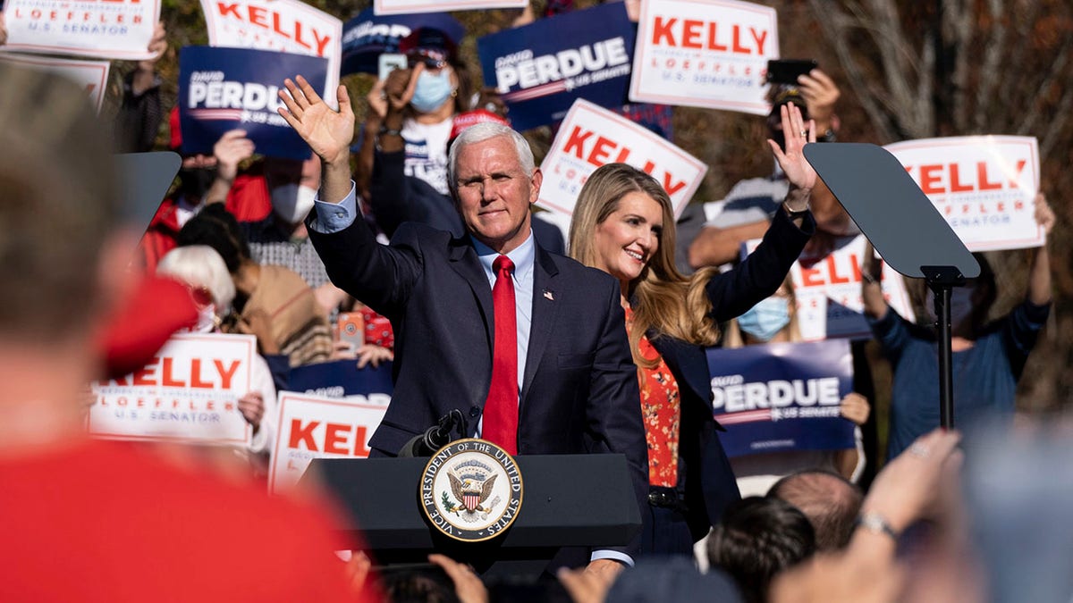 Vice President Mike Pence and Sen. Kelly Loeffler wave to the crowd during a Defend the Majority Rally, Friday, Nov. 20, 2020 in Canton, Ga. (Associated Press)