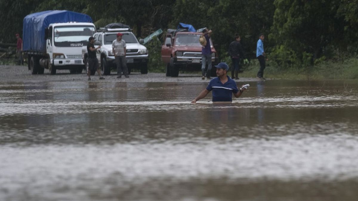 A man walks through a flooded road in Okonwas, Nicaragua, Wednesday, Nov. 4, 2020. Eta weakened from the Category 4 hurricane to a tropical storm after lashing Nicaragua's Caribbean coast for much of Tuesday, its floodwaters isolating already remote communities and setting off deadly landslides. (AP Photo/Carlos Herrera)