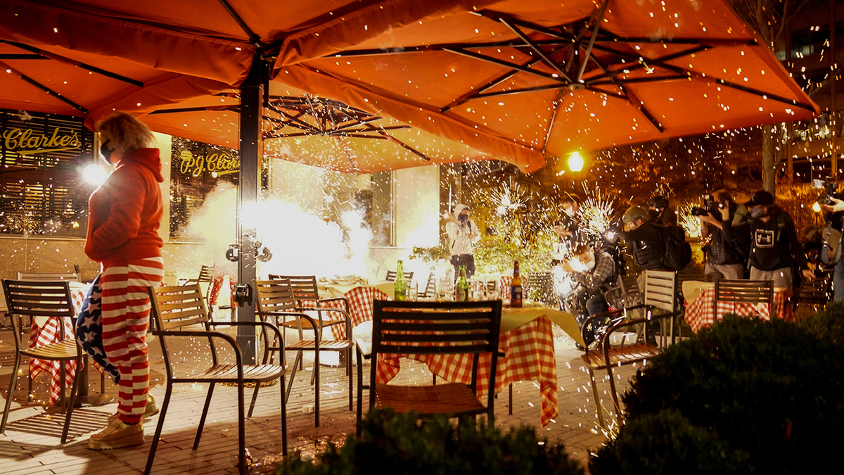 Fireworks were set off at a restaurant where a small crowd of Trump supporters were dining.