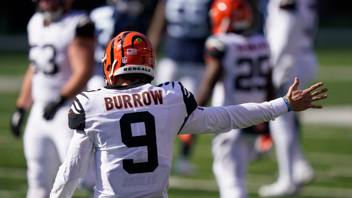 Cincinnati Bengals quarterback Joe Burrow (9) motions a first down during the first half of an NFL football game against the Tennessee Titans, Sunday, Nov. 1, 2020, in Cincinnati. (AP Photo/Bryan Woolston)