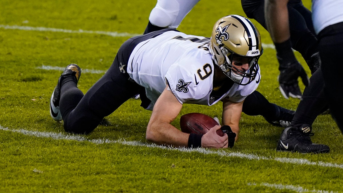 New Orleans Saints quarterback Drew Brees (9) recovers a fumble in the first half of an NFL football game against the Chicago Bears in Chicago, Sunday, Nov. 1, 2020. (AP Photo/Nam Y. Huh)