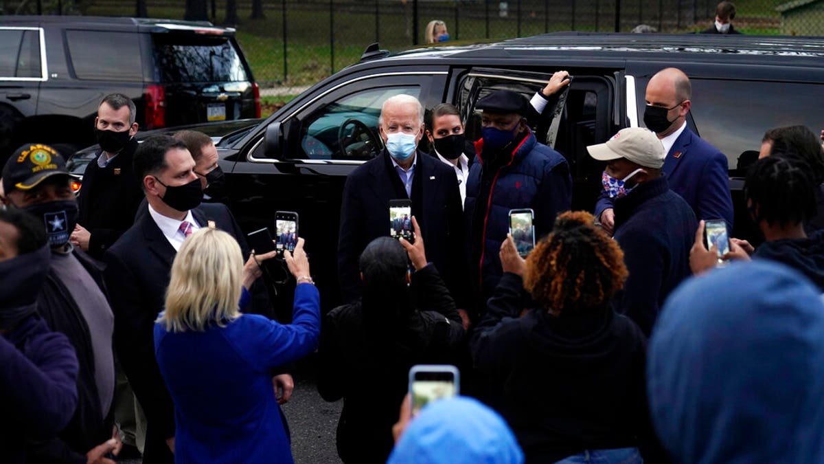 Democratic presidential candidate former Vice President Joe Biden visits with supporters across the street from the Joseph R. Biden Jr. Aquatic Center in Wilmington, Del., Tuesday, Nov. 3, 2020. (AP Photo/Carolyn Kaster)