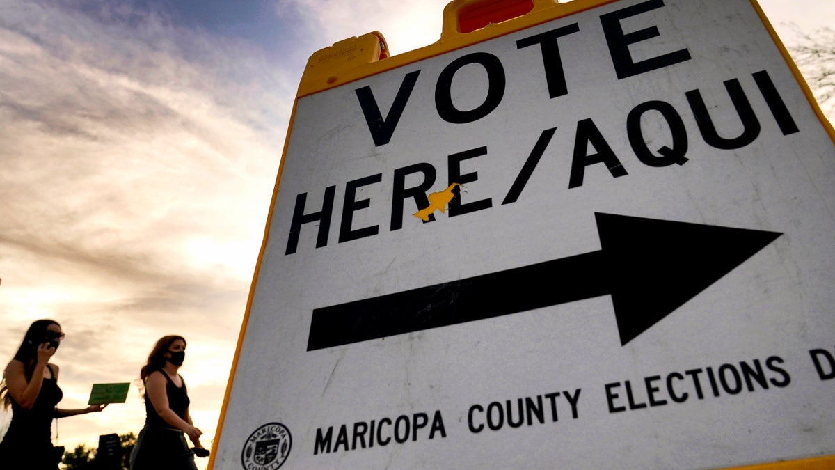 Voters deliver their ballot to a polling station