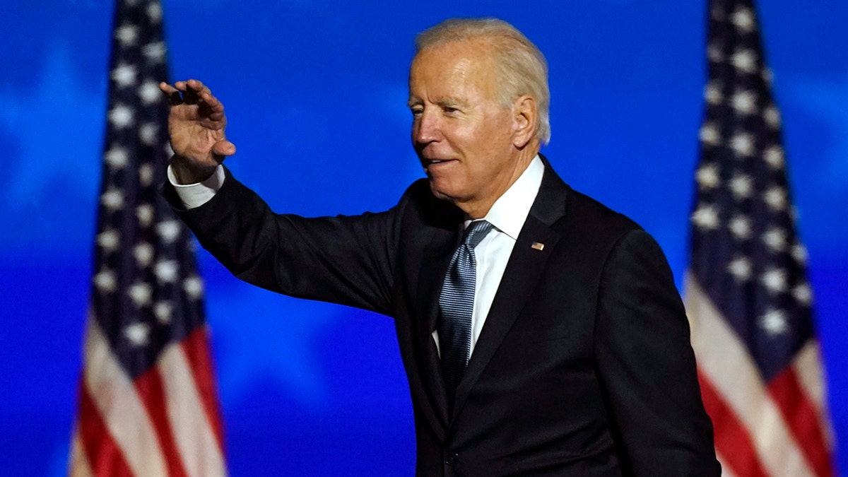 Democratic presidential candidate former Vice President Joe Biden waves to supporters, Tuesday, Nov. 3, 2020, in Wilmington, Del. (AP Photo/Andrew Harnik)