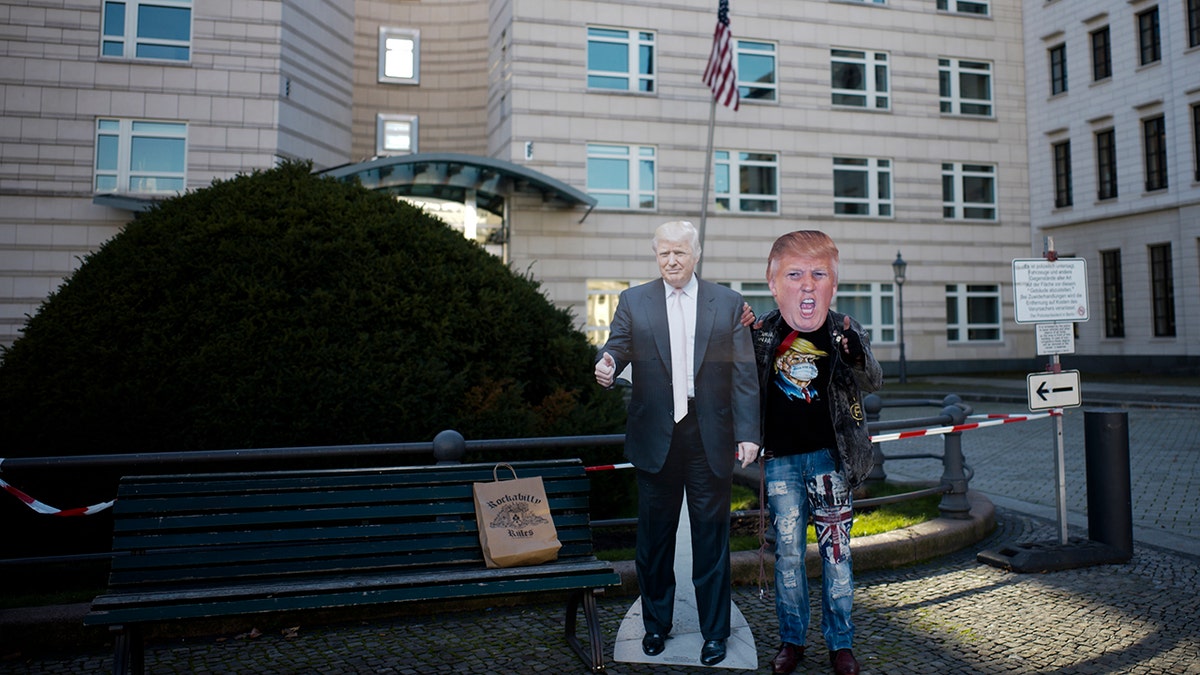Gerd Lindner, who said he's a huge fan of US President Donald Trump, poses near a paper mache effigy of Trump with a Trump mask to support the president a day after the election in the front of the United States embassy in Berlin, Germany, Wednesday, Nov. 4, 2020. (Photo/Markus Schreiber)