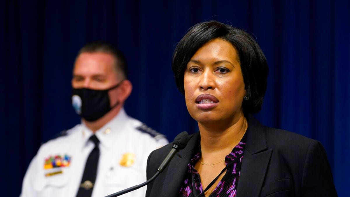 District of Columbia Mayor Muriel Bowser, right, standing next to Metropolitan Police Department chief Peter Newsham, left, speaks during a news conference in Washington, Wednesday, Nov. 4, 2020. (AP Photo/Susan Walsh)