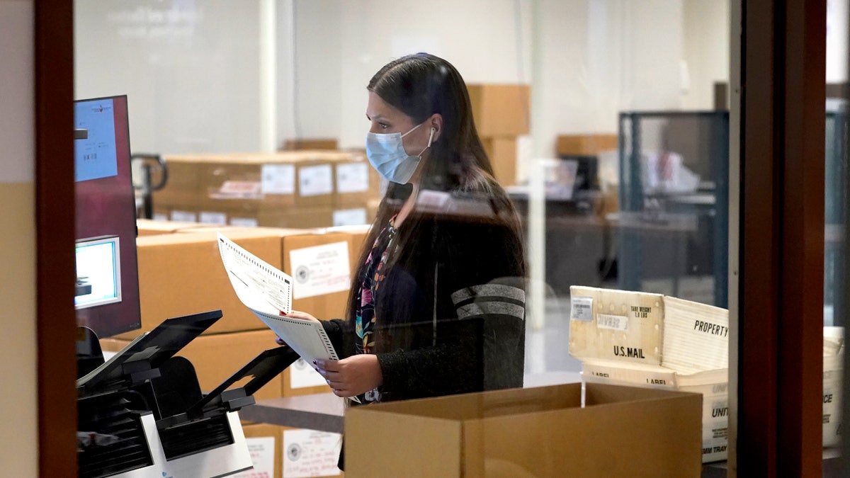 Maricopa County elections officials count ballots, Wednesday, Nov. 4, 2020, at the Maricopa County Recorders Office in Phoenix. (AP Photo/Matt York)
