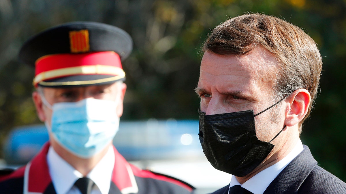 French President Emmanuel Macron arrives at the 'Centre de cooperation policiere et douaniere' (Franco-Spanish Police and Customs Cooperation Center) during a visit on the strengthening border controls at the crossing between Spain and France, at Le Perthus, France, Thursday, Nov. 5, 2020. (Guillaume Horcajuelo, Pool via AP)