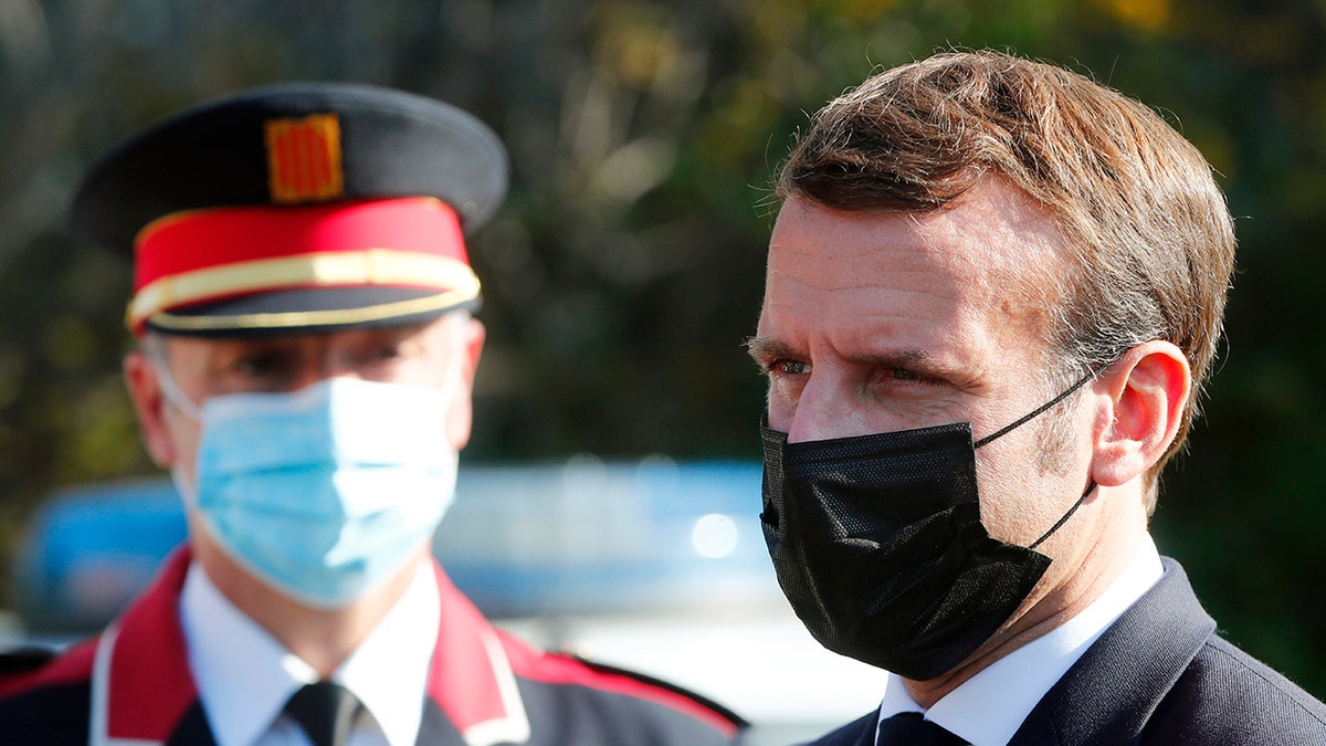 French President Emmanuel Macron arrives at the 'Centre de cooperation policiere et douaniere' (Franco-Spanish Police and Customs Cooperation Center) during a visit on the strengthening border controls at the crossing between Spain and France, at Le Perthus, France, Thursday, Nov. 5, 2020. (Guillaume Horcajuelo, Pool via AP)
