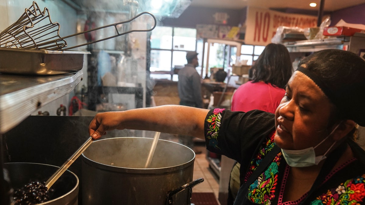 Natalia Méndez cooks in the kitchen of La Morada, an award winning Mexican restaurant she co-owns with her family in South Bronx, Wednesday Oct. 28, 2020, in New York. (AP Photo/Bebeto Matthews)