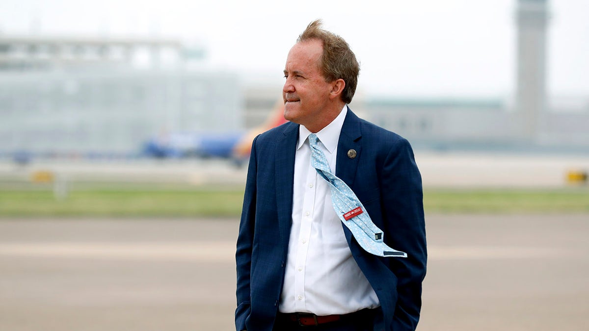 In this June 28, 2020, file photo, Texas Attorney General Ken Paxton waits on the flight line for the arrival of Vice President Mike Pence at Love Field in Dallas. Paxton had an extramarital affair with a woman whom he later recommended for a job with the wealthy donor now at the center of criminal allegations against him, according to two people who said Paxton told them about the relationship. (AP Photo/Tony Gutierrez, File)