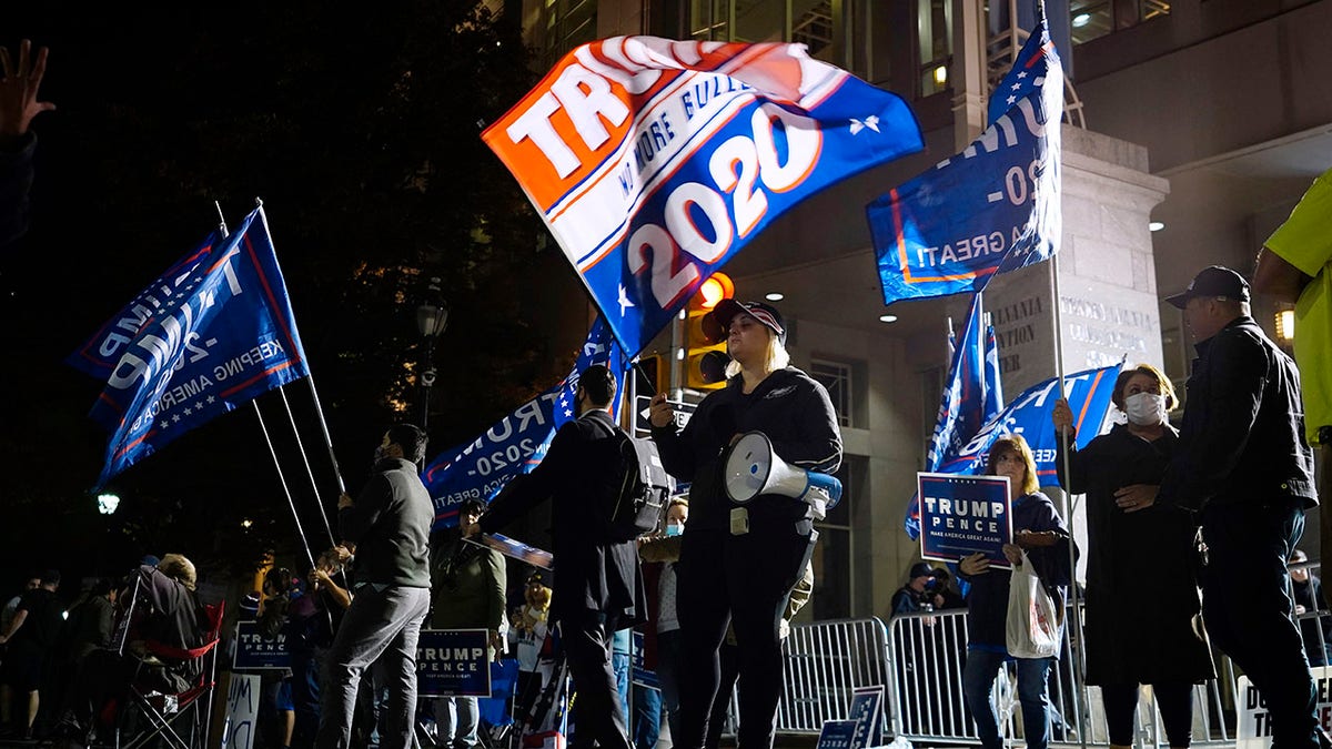 Supporters of President Trump stand outside the Pennsylvania Convention Center where votes are being counted, Thursday, Nov. 5, 2020, in Philadelphia, following Tuesday's election. (AP Photo/Matt Slocum)