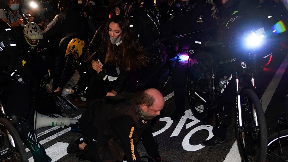 New York Police bike patrol officers corral demonstrators and members of the media during a march through the West Village, on Thursday. (Associated Press)