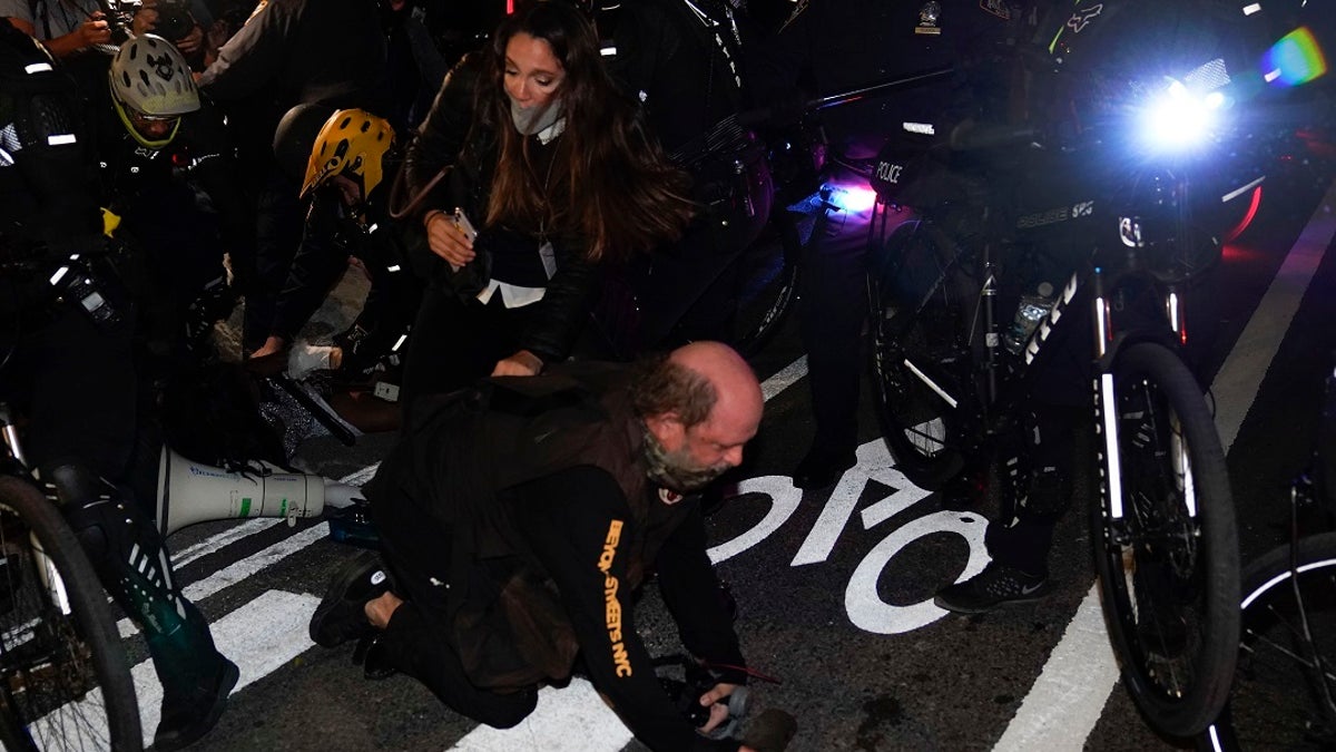 New York Police bike patrol officers corral demonstrators and members of the media during a march through the West Village, on Thursday. (Associated Press)