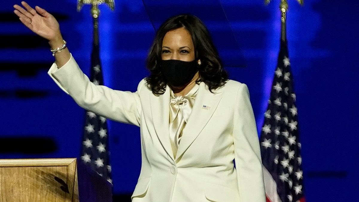 Vice President-elect Kamala Harris waves as she takes the stage before speaking, Saturday, Nov. 7, 2020, in Wilmington, Del. (AP Photo/Andrew Harnik, Pool)